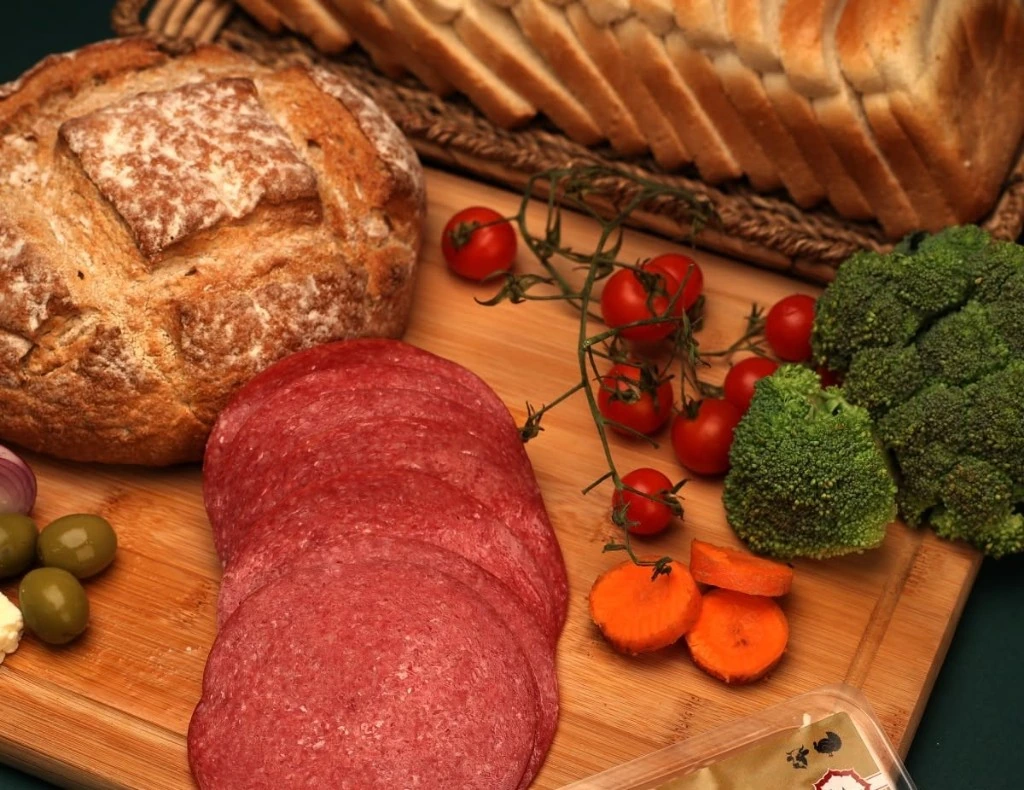 Bosna halal salami slices with fresh bread and vegetables