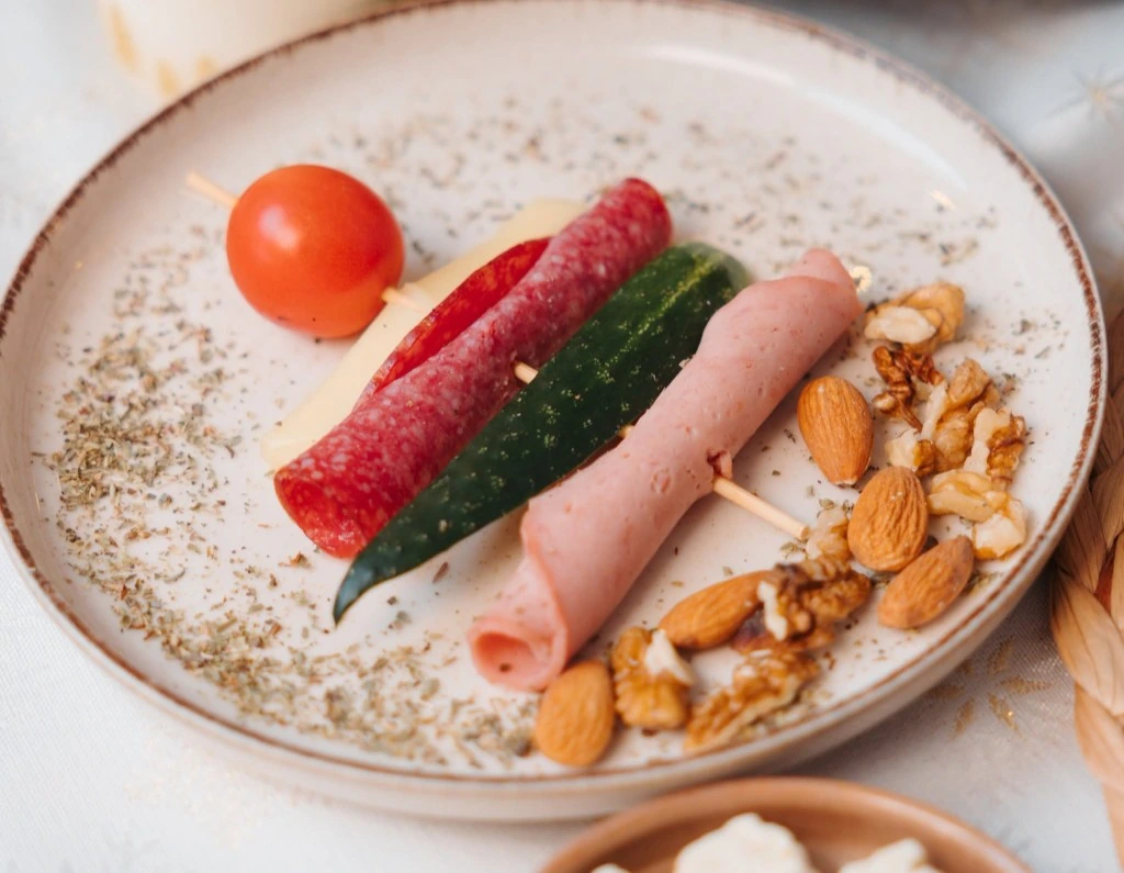 Bosna appetizer skewer with salami, cheese and pickles