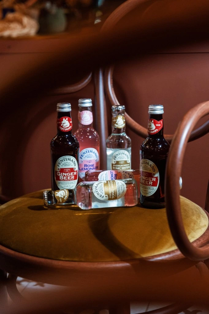 Fentimans botanical drinks arranged on a velvet chair
