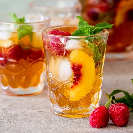 Juicy iced fruit drink with peach and raspberry