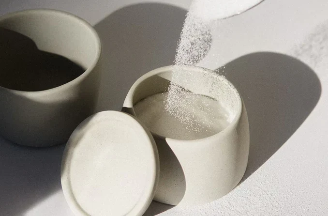 Sugar poured into a ceramic jar