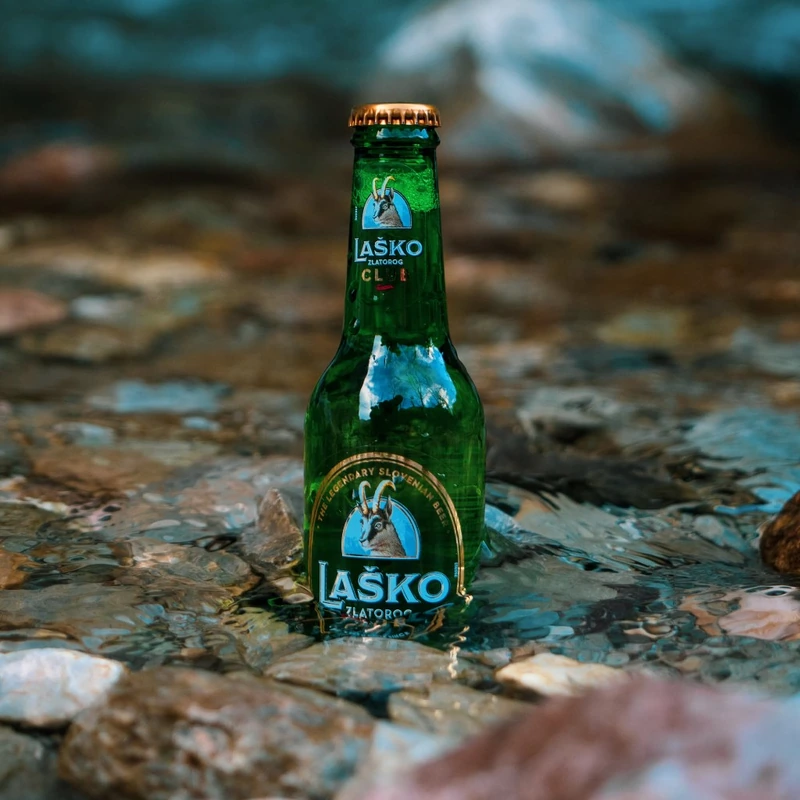 Laško Zlatorog bottle in a mountain stream