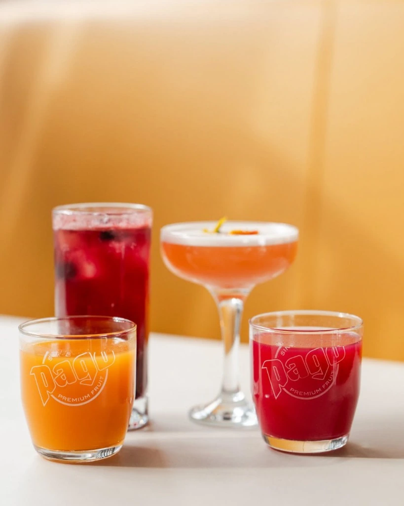 Pago premium fruit juices served in colorful glasses