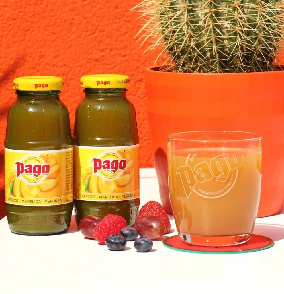 Pago apricot juice bottles with fresh fruit