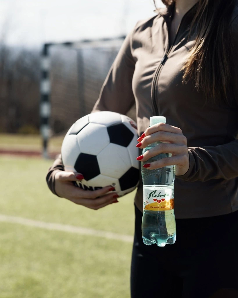 Radenska mango lime water on a soccer field